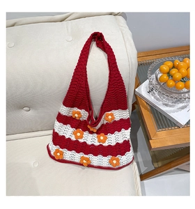 Detailed view of handmade crochet tote with red stripes and 3D floral accents