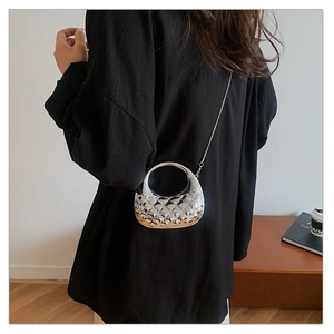 Detail of silver metallic rhombic cut-out acrylic evening bag with chain strap