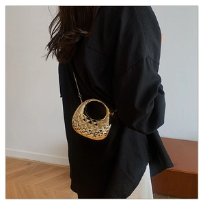 Detailed close-up of a gold acrylic mini bag featuring geometric facets and metal chain