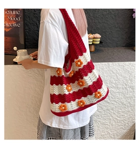Detail of red and white striped knit tote bag with handmade yellow floral embellishments