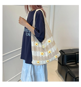 Detail of hand-crocheted beige striped tote bag with 3D yellow flower embellishments