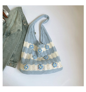 Detail of blue and white striped knit tote bag with handmade daisy floral appliqués