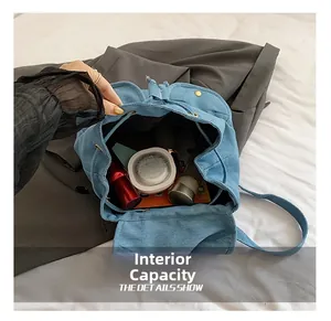 Top view of blue denim backpack interior showing large capacity for daily essentials