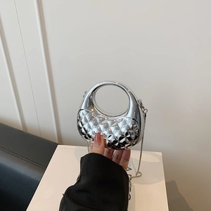 Silver quilted acrylic mini handbag with round cutout handle and metallic chain strap