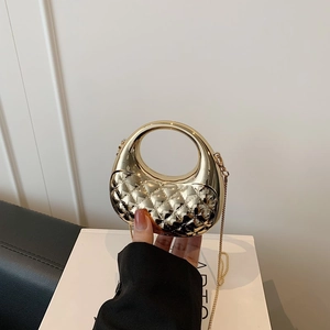 Chic mini gold metal handbag with quilted pattern and round handle for crossbody or hand carry