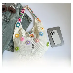 Detail shot of hand-woven floral crochet tote bag showing spacious capacity for tablets