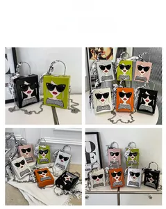 Detail of colorful mini square handbags with chic silk scarf and cartoon girl graphic