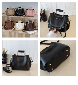 Detailed view of the metal frame handle, decorative chain, and anti-wear studs on the bag