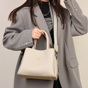 Elegant off-white lychee grain leather handbag with wide shoulder strap for women