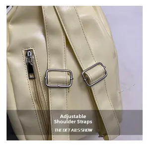 Detail of cream PU leather backpack featuring adjustable straps and silver metal buckles