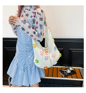 Detailed close-up of handmade crochet flower tote bag with colorful knitted patterns