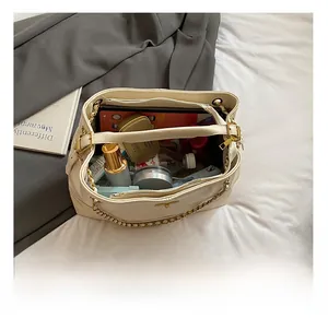 Detail view of large capacity tote bag interior showing storage for tablets and cosmetics