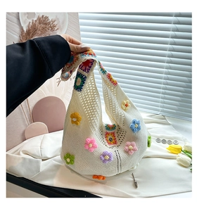 Detailed close-up of handmade crochet tote bag with colorful 3D floral accents