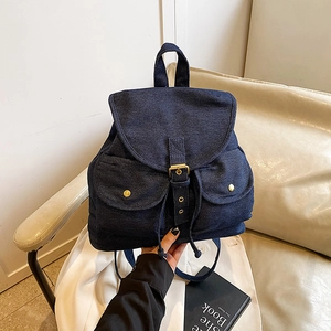 Deep blue denim backpack with flap cover and vintage metal buckles for daily travel