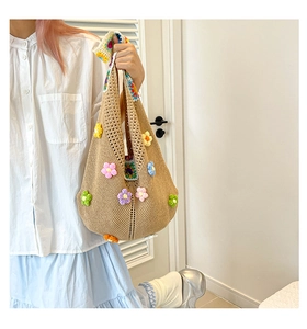 Close-up of khaki woven tote bag featuring colorful 3D knit floral patterns and texture
