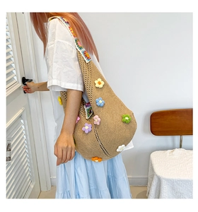 Close-up of handmade crochet flower tote with colorful floral textures and ethnic shoulder strap