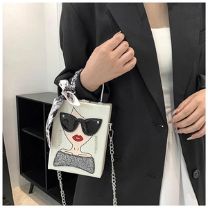 Detail of white box bag with fashion character illustration and silk scarf on handle
