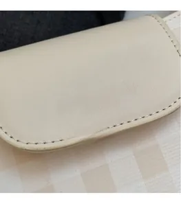 Close-up of beige leather texture with silver embossed Fashion & Bags lettering
