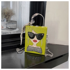 Detail of neon green box bag featuring pop art illustration and silk scarf handle