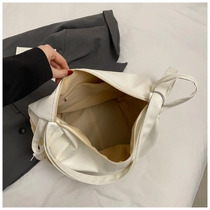 Internal view of cream PU leather shoulder bag showing zipper pocket and spacious lining