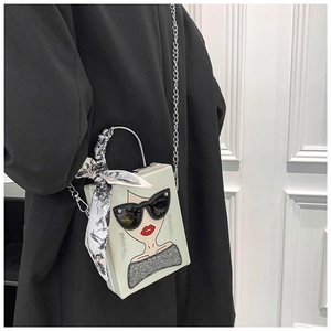 Detail of creative box bag with silk scarf handle and chic sequined sunglasses print