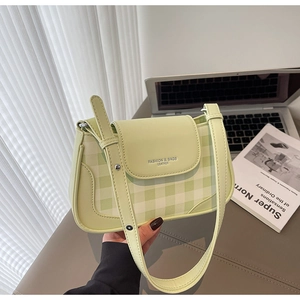 Close-up of pistachio green plaid underarm bag with Fashion & Bags logo engraving