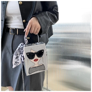 Detail of silver box bag featuring fashion portrait illustration and silk scarf handle