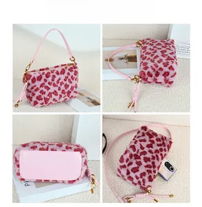 Pink and red leopard print plush crossbody bag with leather strap and metal hardware details