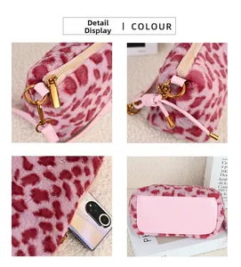 Detail view of pink leopard plush bag showing zipper, metal hooks and spacious interior