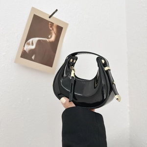Chic black patent leather mini crescent handbag with golden hardware for trendy women