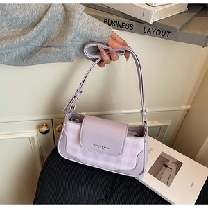 Detail of light purple plaid underarm bag with adjustable strap and flap closure