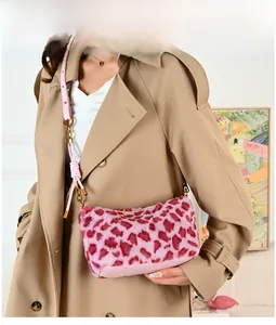 Detail of pink leopard print plush crossbody bag with knot strap on khaki coat