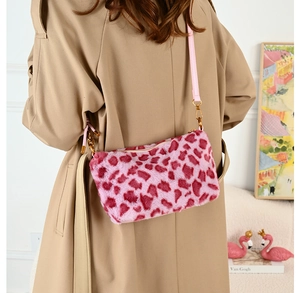 Detail shot of the plush pink leopard print crossbody bag with gold metal hardware
