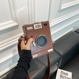 Creative vintage camera shaped shoulder bag in brown pleated leather with lens detail