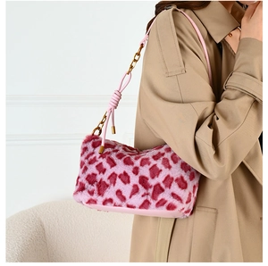 Close-up of pink leopard plush bag with faux fur texture and gold chain strap