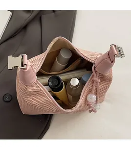 Pink woven handbag interior showing spacious capacity with a silver metal clasp