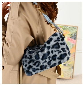 Detail of blue and grey leopard faux fur bag with gold chain and blue leather strap