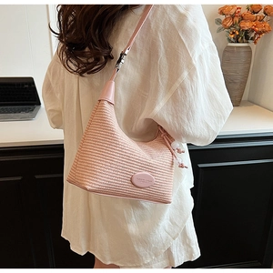 Detail of pink woven hobo bag showing fabric texture, zipper closure and leather strap
