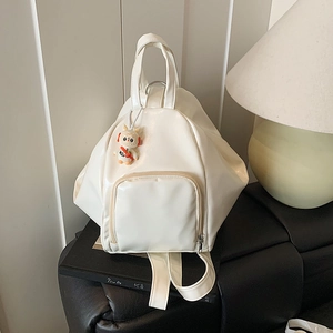 Minimalist creamy white PU leather backpack with geometric shape and cute rabbit charm