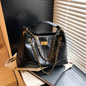 Chic black quilted tote bag with gold chain strap and vintage metal twist lock