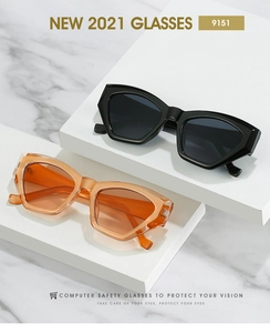 Detailed view of geometric cat eye sunglasses in black and transparent orange acetate frames