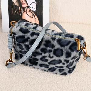 Chic leopard print faux fur handbag with blue leather strap and golden zipper