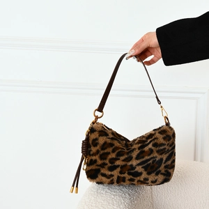 Chic leopard print faux fur shoulder bag with brown leather strap and gold ring details
