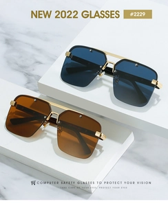 Detail of oversized square sunglasses with gold metal double-bridge and studded lenses