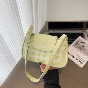 Light green checkered baguette shoulder bag with adjustable strap and flap closure