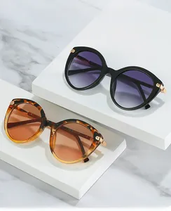 Detail of round sunglasses with vintage tortoiseshell frames and gold metal accents