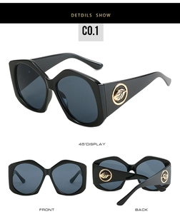 Détail de lunettes de soleil losanges oversize avec accent de feuille dorée sur monture noire