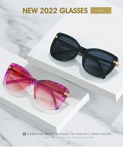 Detail of square-round sunglasses with gold metal hinges and protective lenses