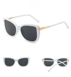 Detailed views of white cat-eye sunglasses with dark lenses and gold metal temple accents