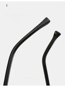 Detail of black cat eye sunglasses featuring textured hammered temples and curved arms
